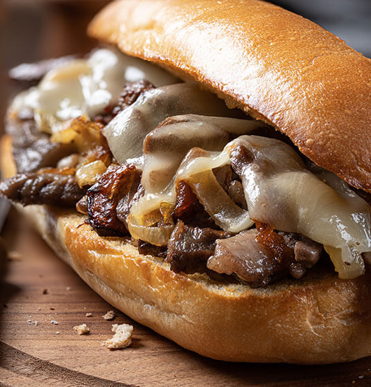 half cow philly cheesesteak sandwich